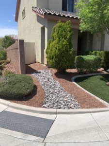Front yard of a house with rock formation footpath